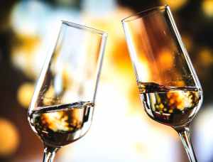 bokeh photo of two toast clear glass wine glasses